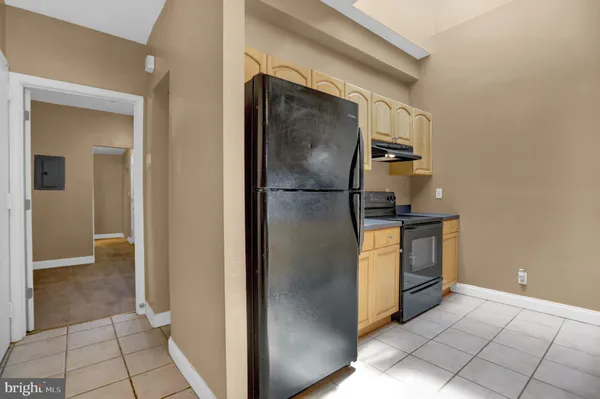 a view of a refrigerator and an empty room