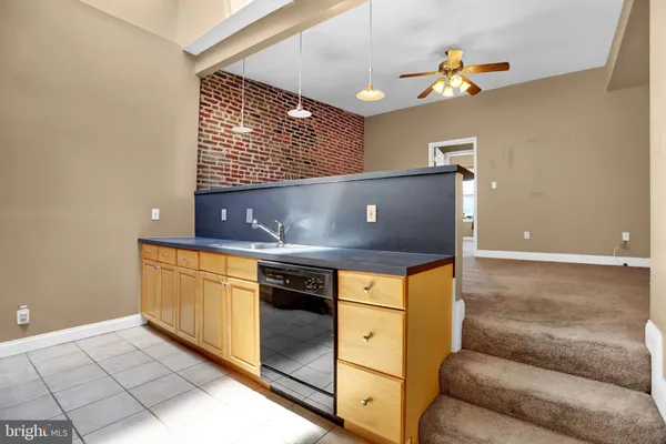 a kitchen with stainless steel appliances granite countertop a sink and a stove