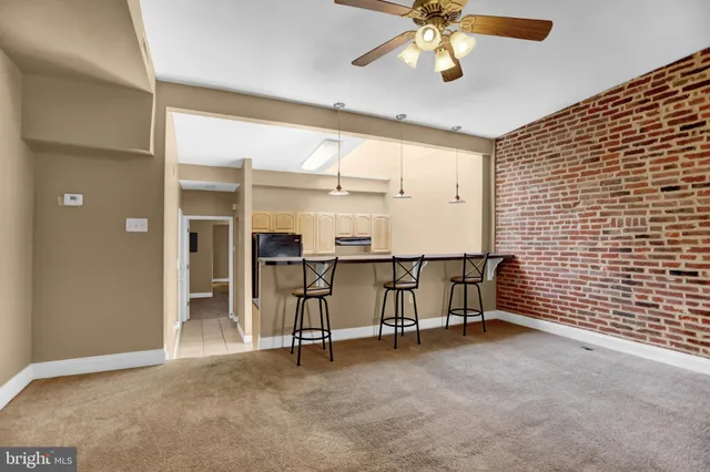 a view of an empty room with a ceiling fan