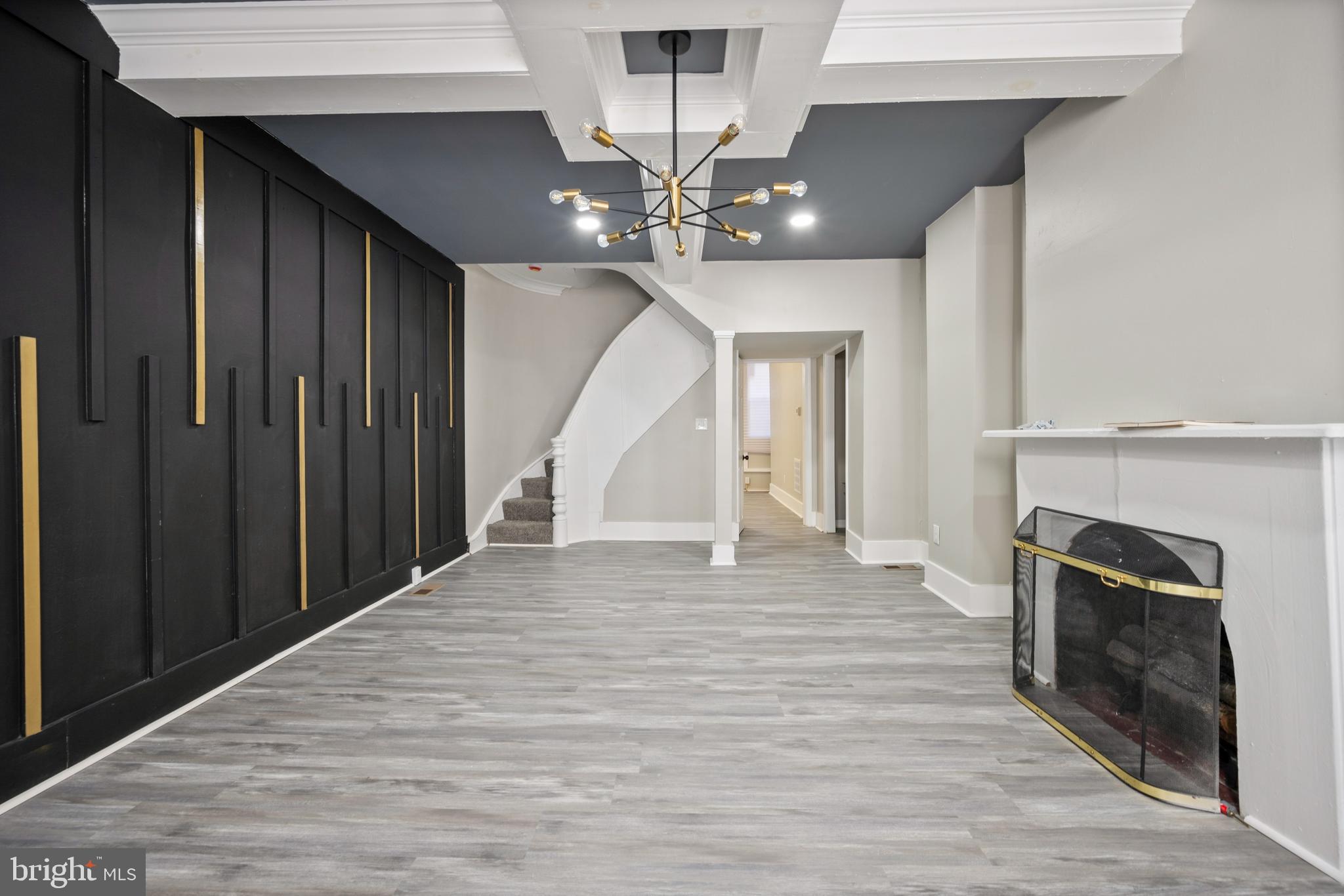 1038 Brantley Avenue Baltimore, MD 21217 - Photo 11 of 38 a view of an empty room with wooden floor fireplace and a window