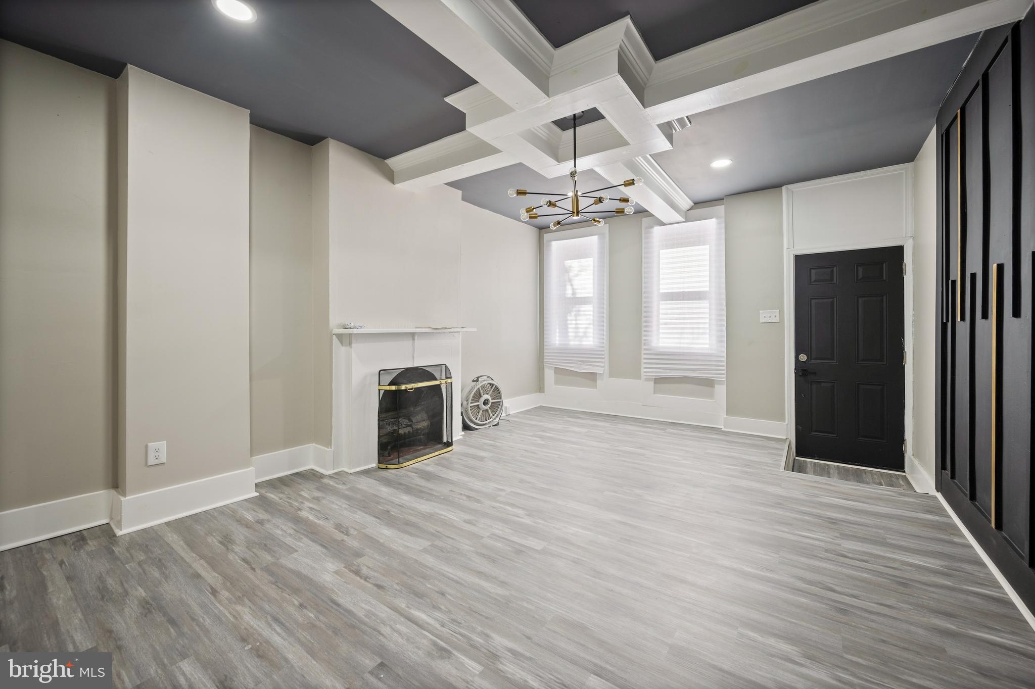 1038 Brantley Avenue Baltimore, MD 21217 - Photo 12 of 38 an empty room with chandelier fan and windows