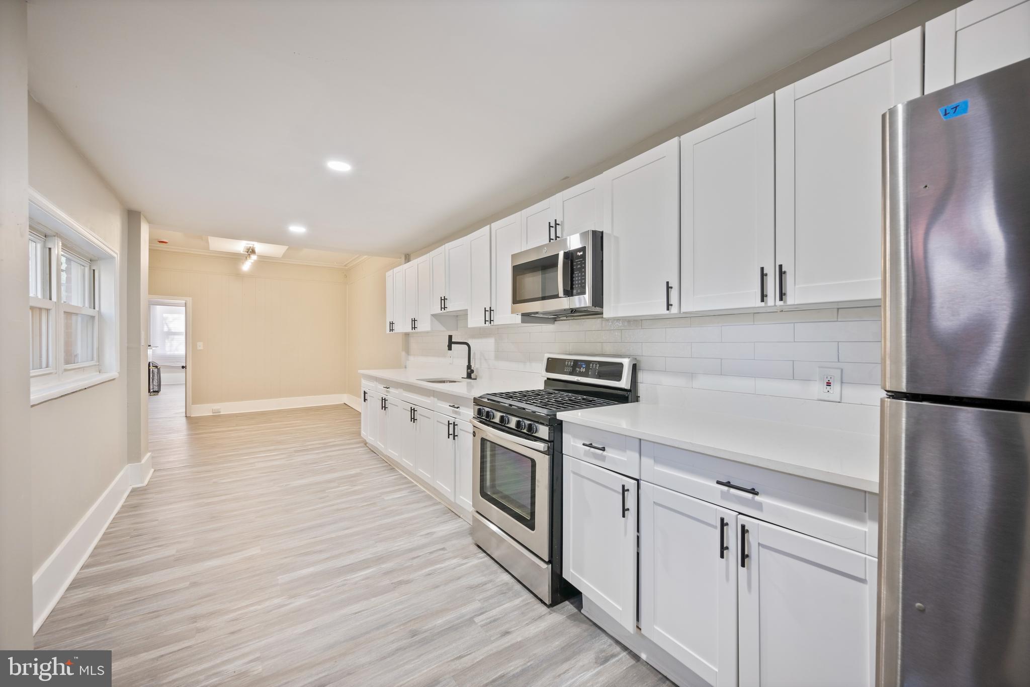 1038 Brantley Avenue Baltimore, MD 21217 - Photo 17 of 38 a kitchen with stainless steel appliances a refrigerator stove and white cabinets