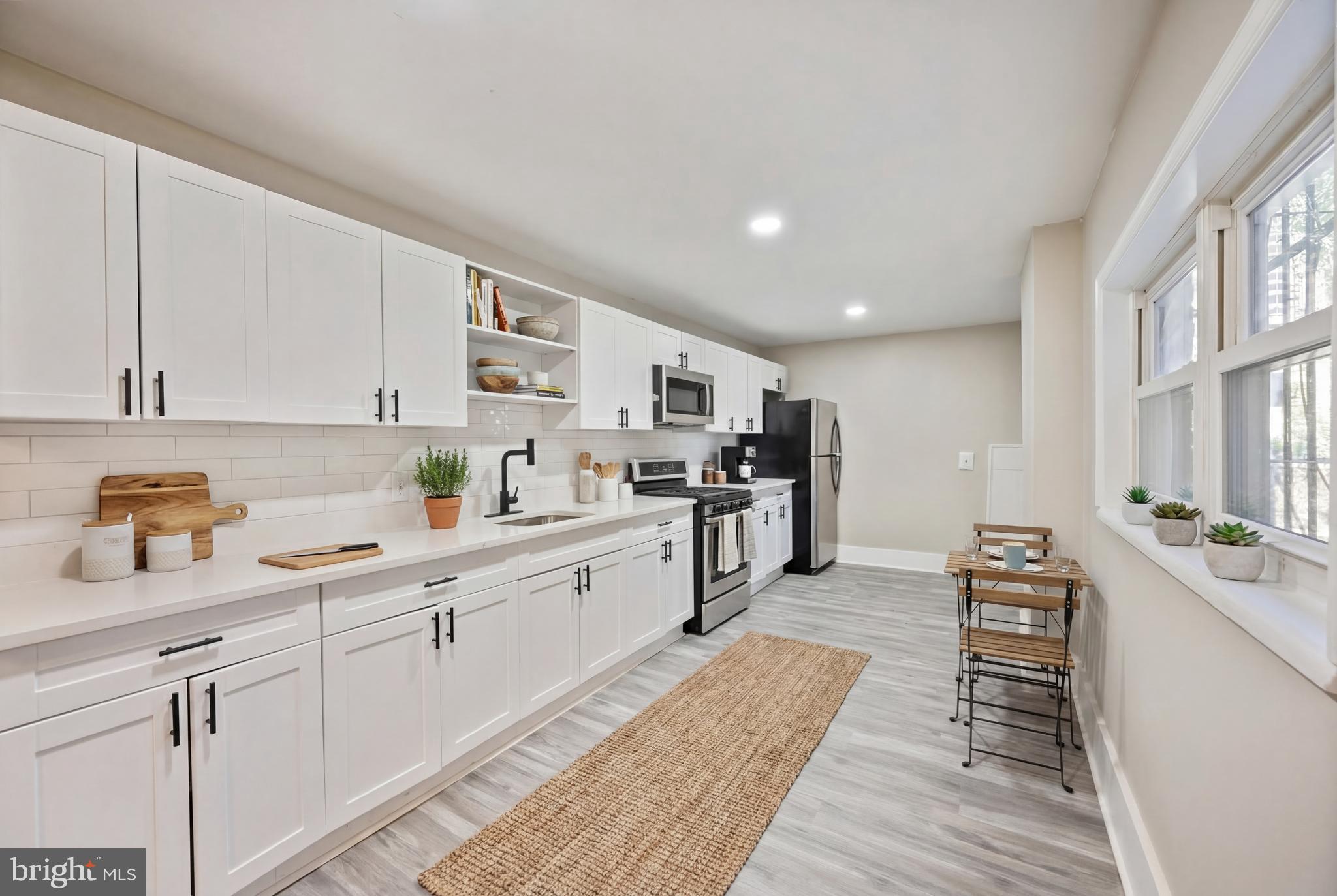 1038 Brantley Avenue Baltimore, MD 21217 - Photo 2 of 38 a kitchen with cabinets and wooden floor