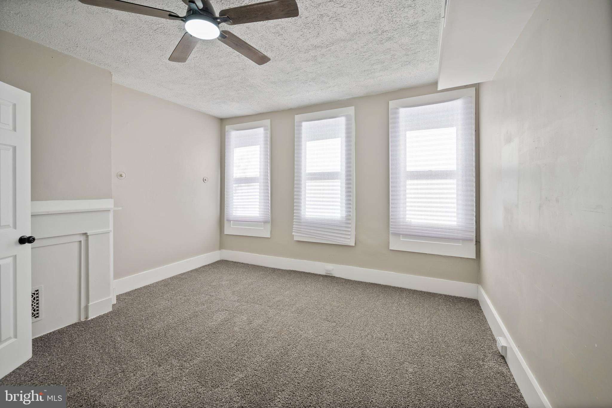 1038 Brantley Avenue Baltimore, MD 21217 - Photo 21 of 38 an empty room with windows and fan