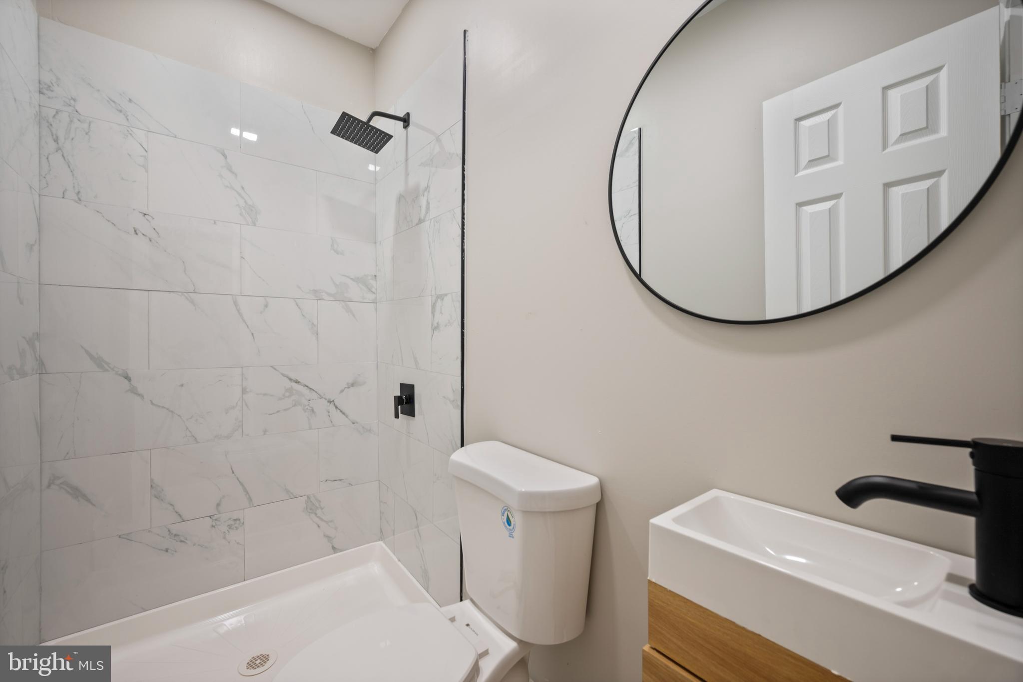 1038 Brantley Avenue Baltimore, MD 21217 - Photo 23 of 38 a bathroom with a sink a toilet and a mirror