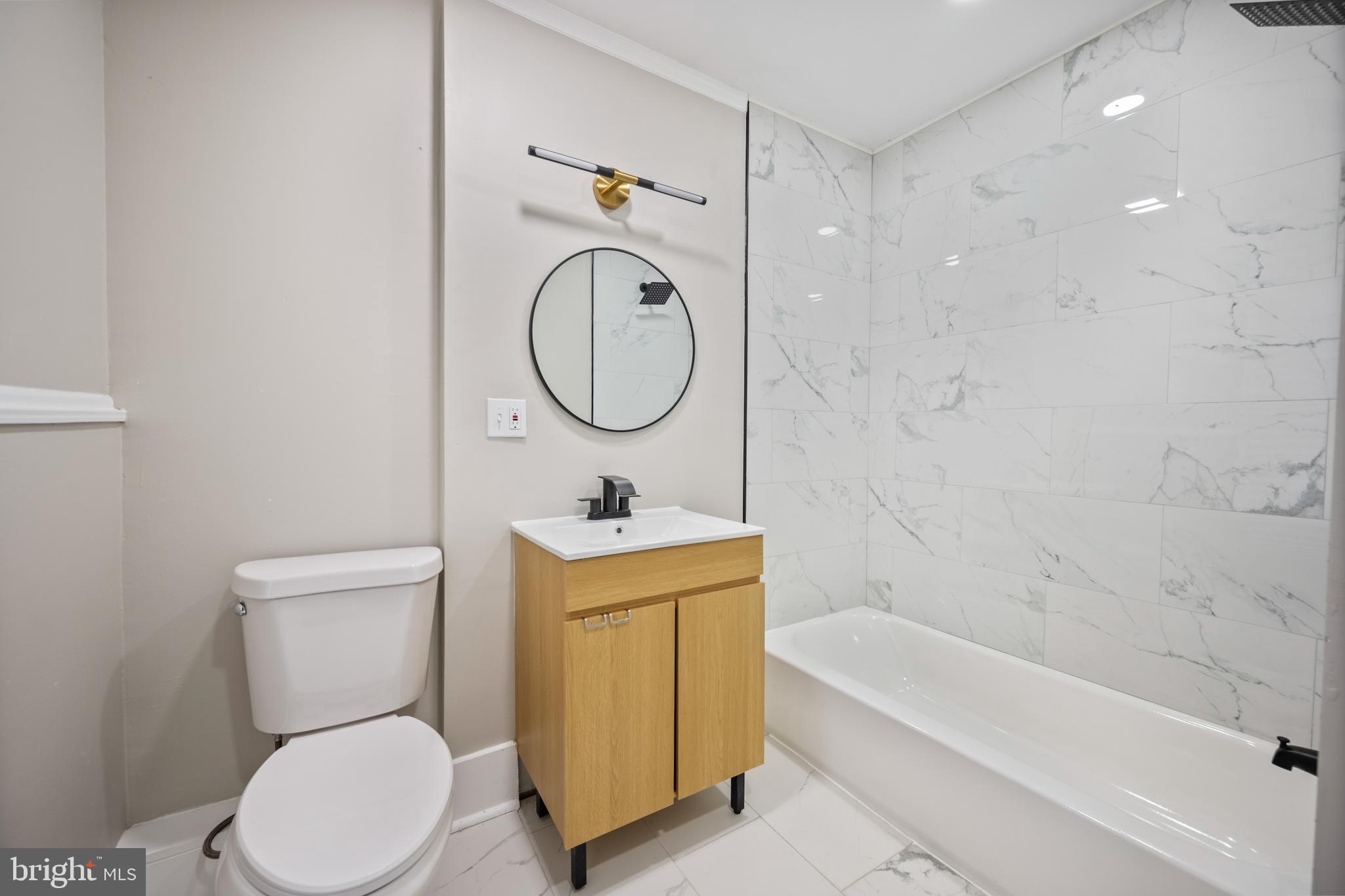 1038 Brantley Avenue Baltimore, MD 21217 - Photo 25 of 38 a bathroom with a toilet sink vanity tub and shower