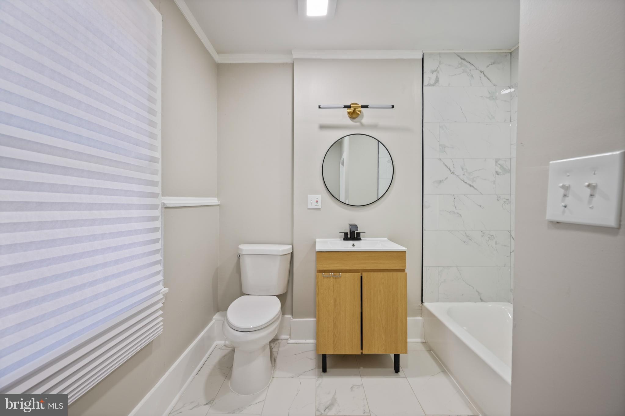 1038 Brantley Avenue Baltimore, MD 21217 - Photo 26 of 38 a bathroom with a toilet a sink and a bathtub