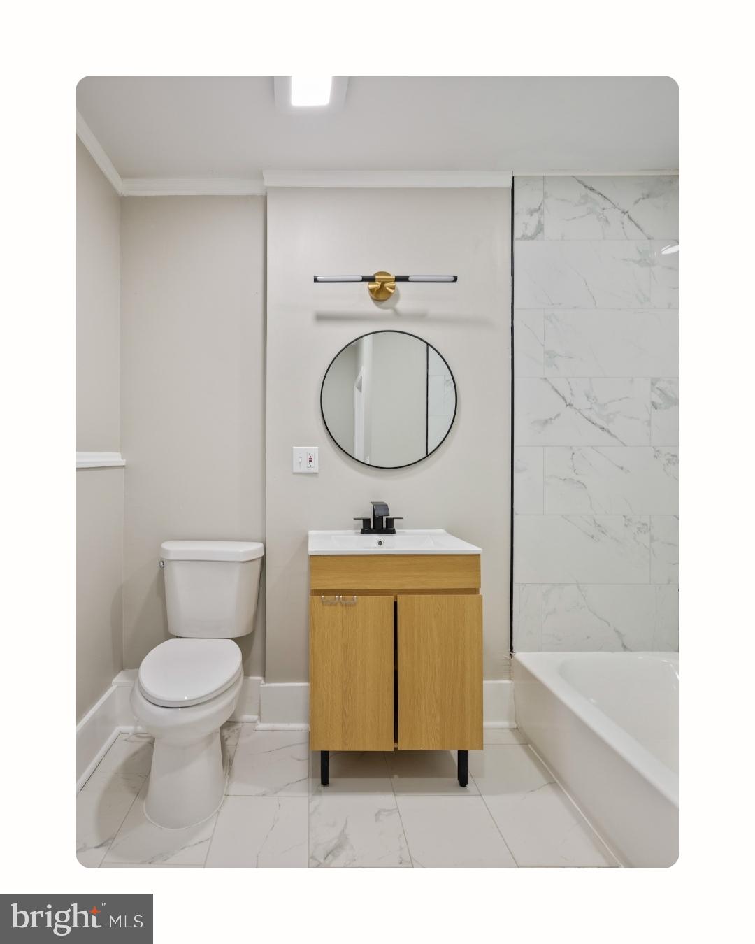 1038 Brantley Avenue Baltimore, MD 21217 - Photo 27 of 38 a bathroom with a toilet a sink and bathtub