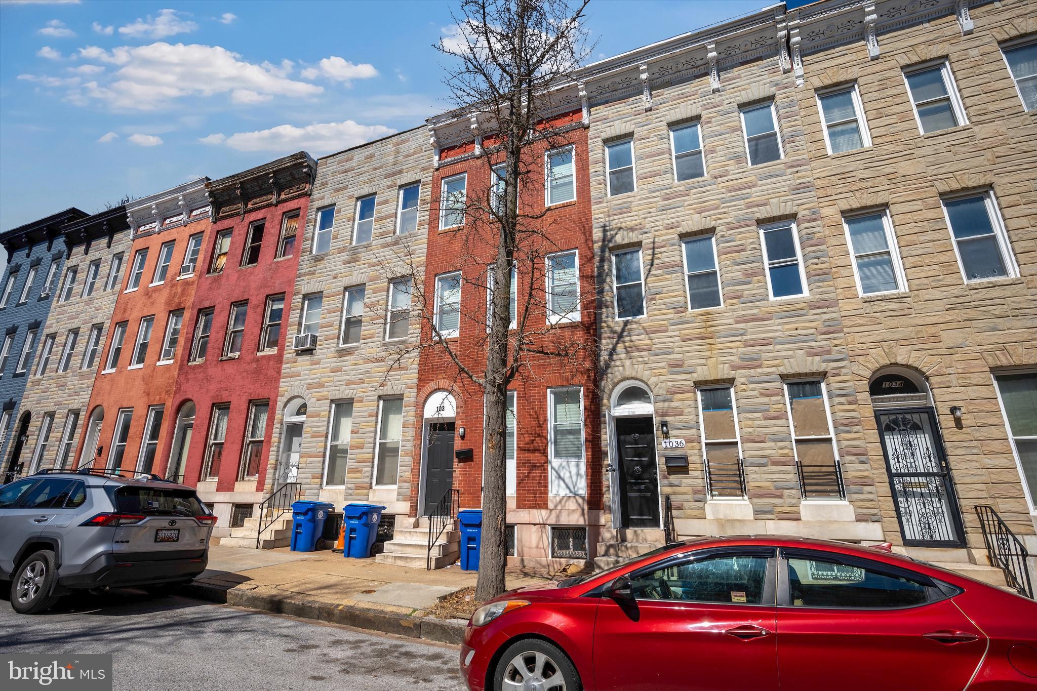 1038 Brantley Avenue Baltimore, MD 21217 - Photo 37 of 38 a front view of a building with lot of cars and trees