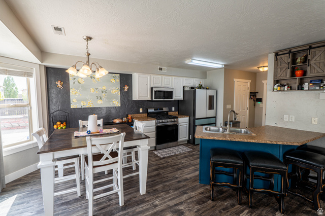 1443 West 250 North Springville, UT 84663 - Photo 9 of 23 Open-concept kitchen and dining area featuring wood-finish flooring