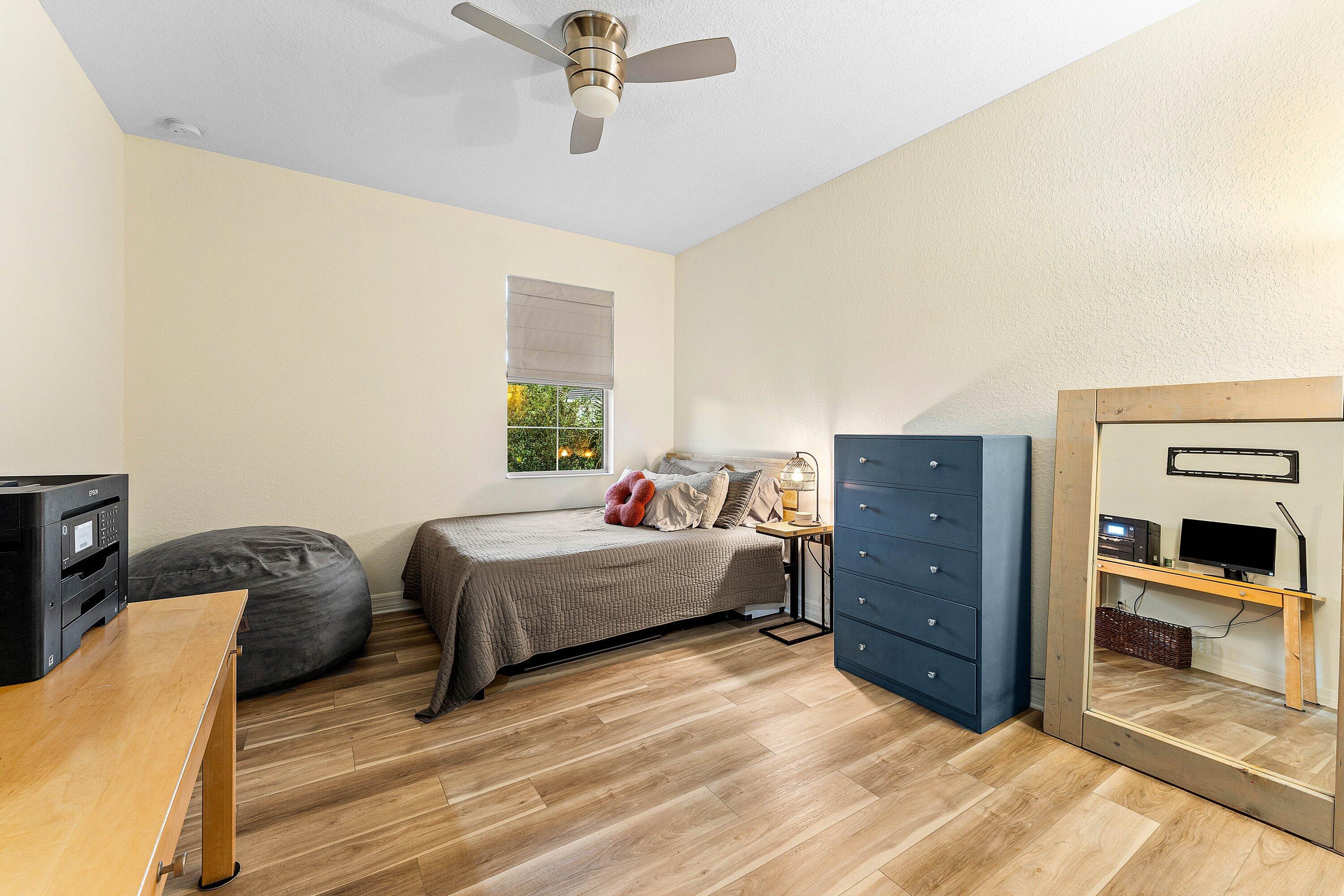 1056 Community Drive Jupiter, FL 33458 - Photo 17 of 50 a bed room with a bed and a television