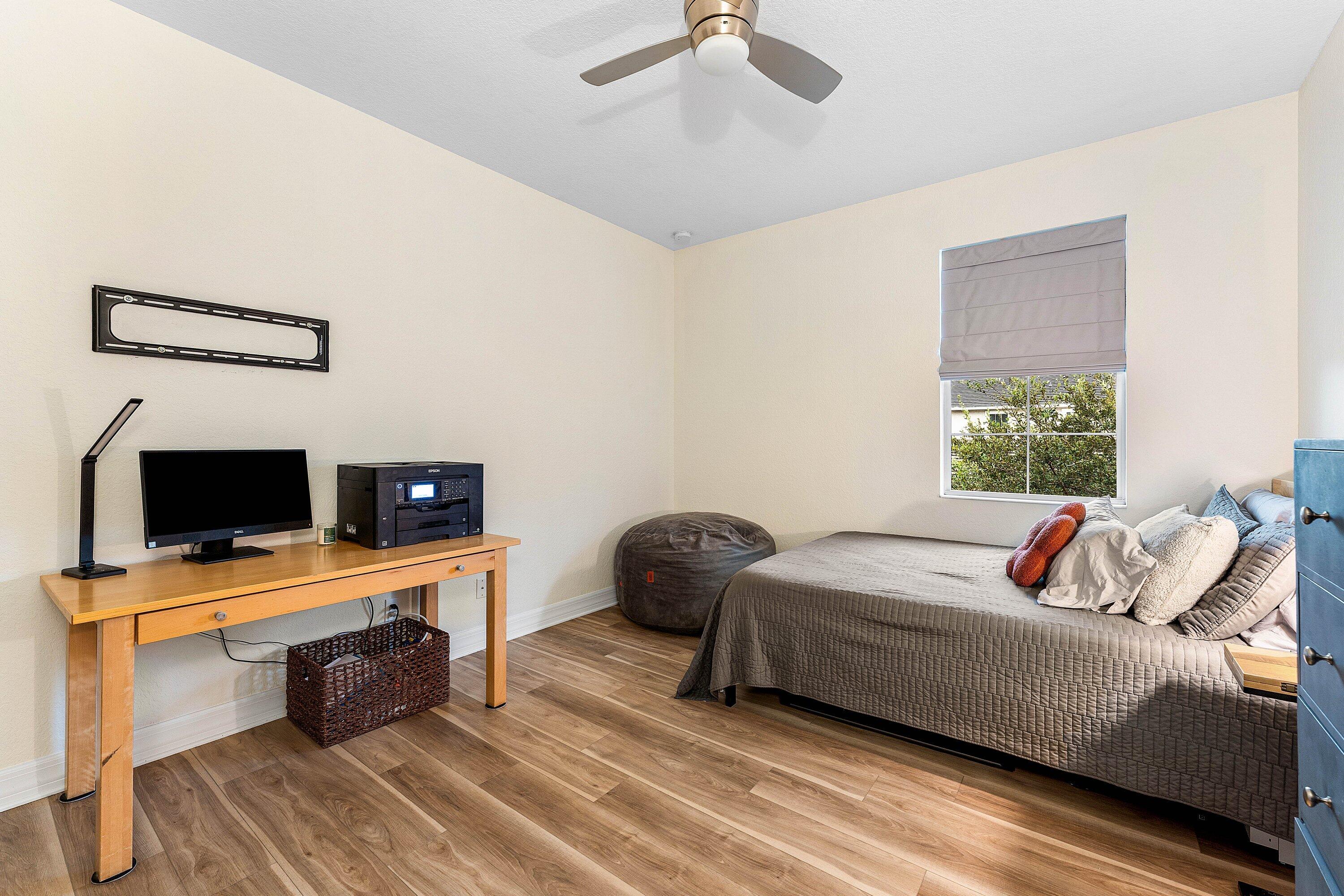 1056 Community Drive Jupiter, FL 33458 - Photo 18 of 50 a bedroom with a bed and a window