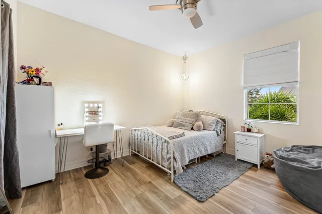 a bedroom with a bed and a wooden floor