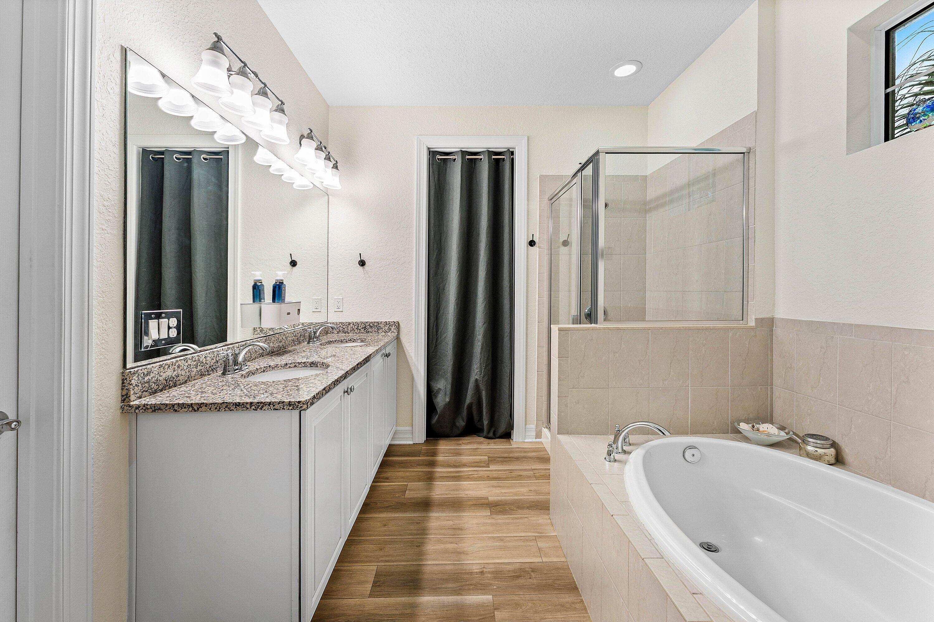 1056 Community Drive Jupiter, FL 33458 - Photo 24 of 50 a bathroom with a granite countertop sink and a mirror