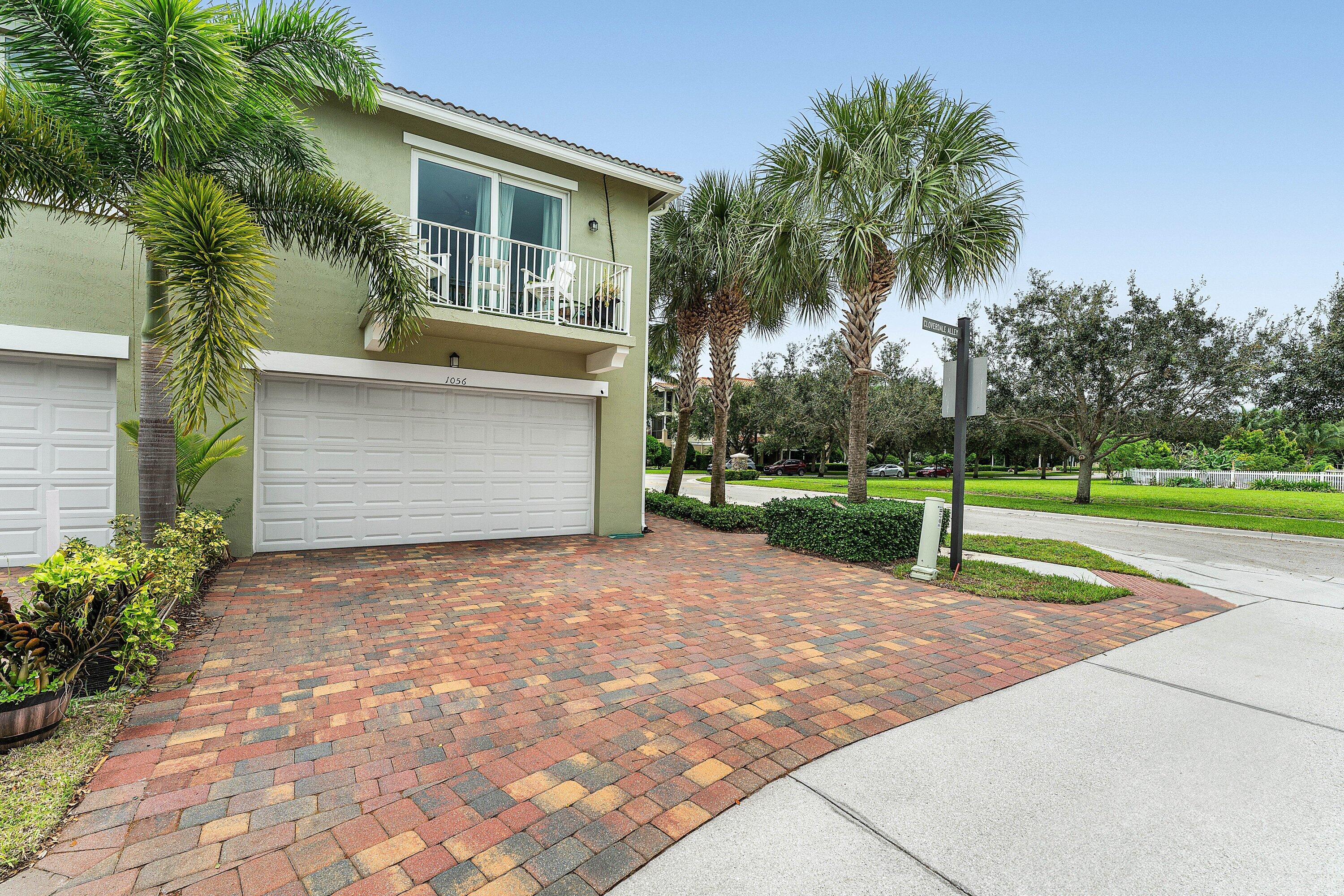1056 Community Drive Jupiter, FL 33458 - Photo 32 of 50 a view of a backyard with a plants and palm trees