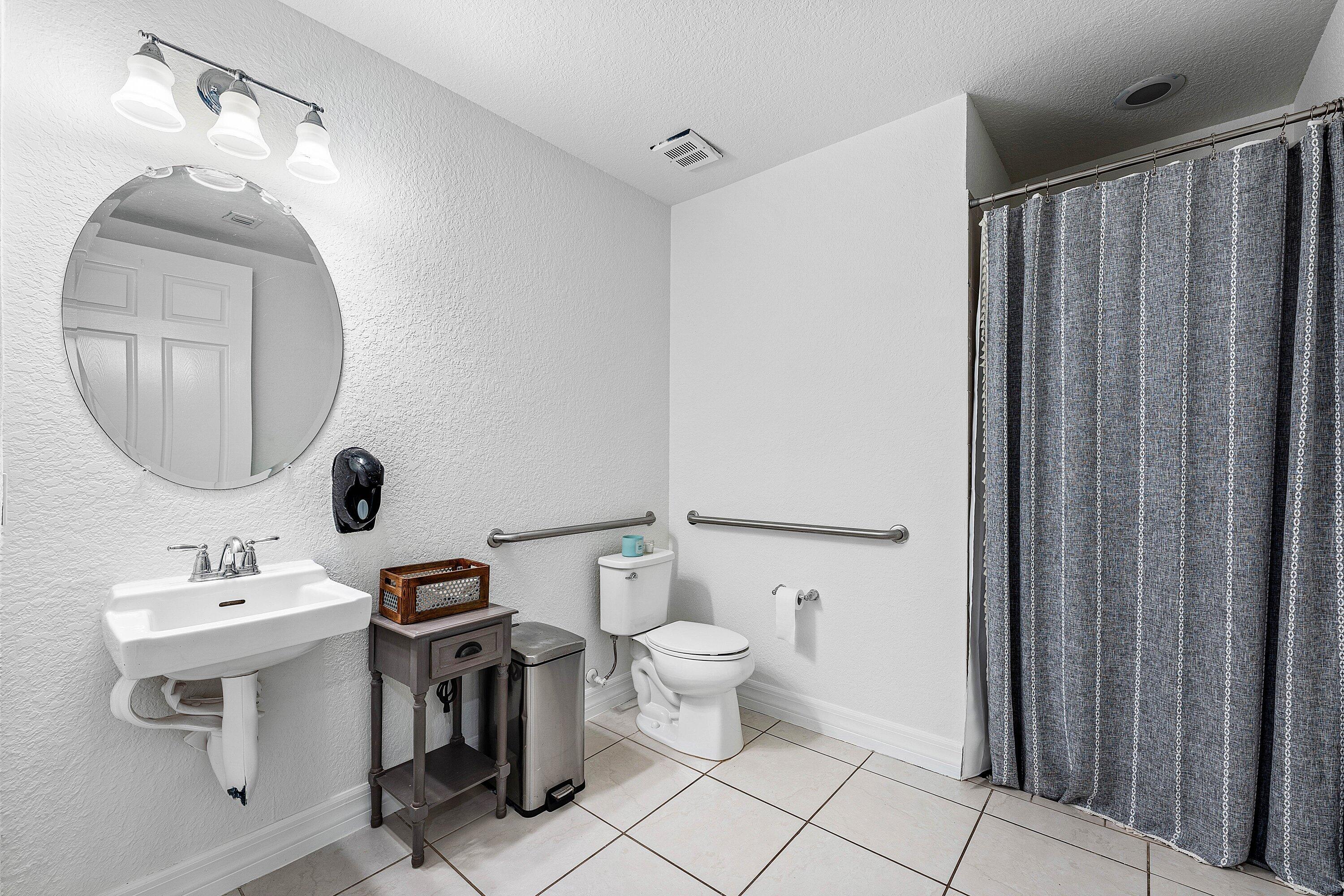 1056 Community Drive Jupiter, FL 33458 - Photo 42 of 50 a bathroom with a toilet sink and mirror