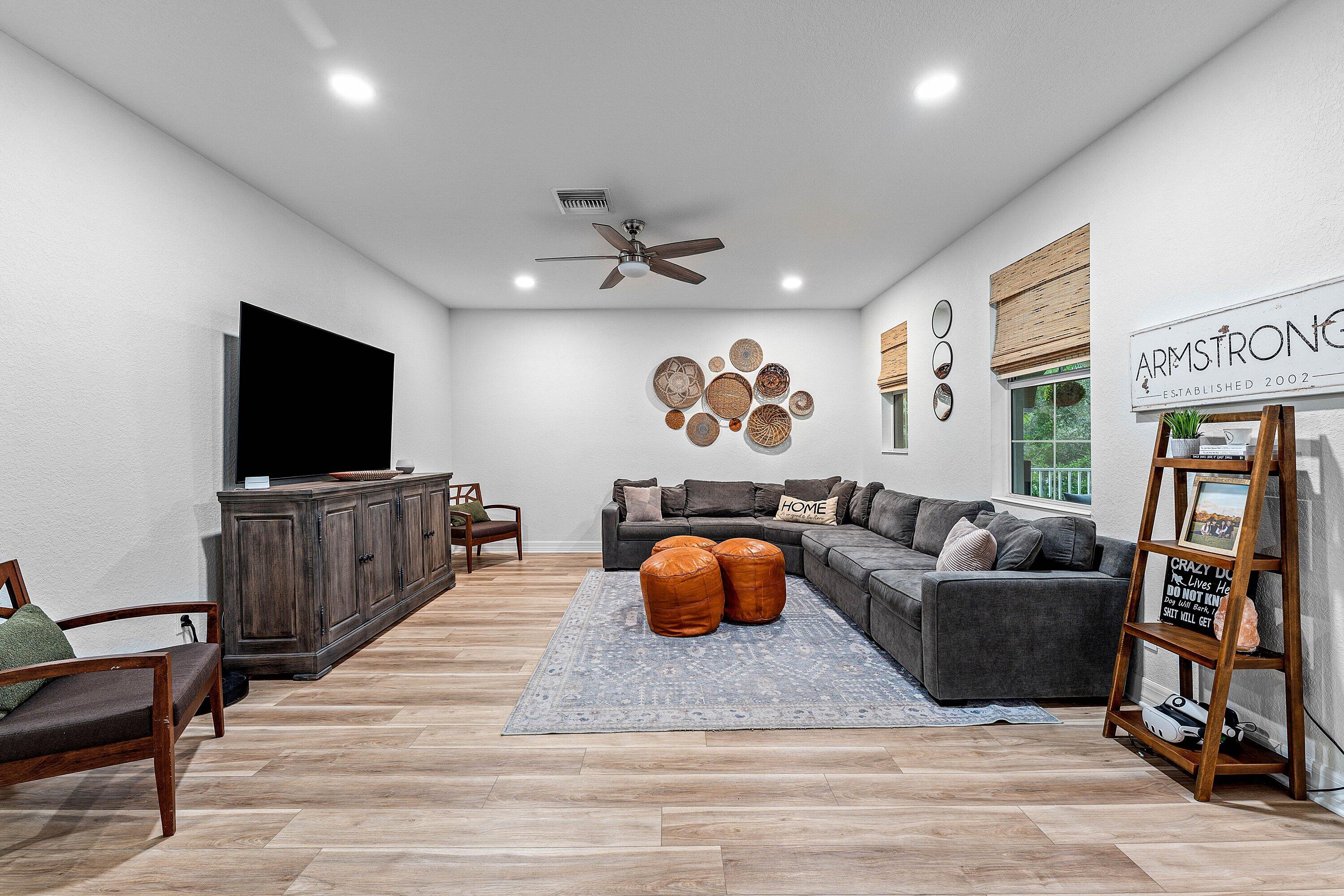 1056 Community Drive Jupiter, FL 33458 - Photo 10 of 50 a living room with furniture and a flat screen tv