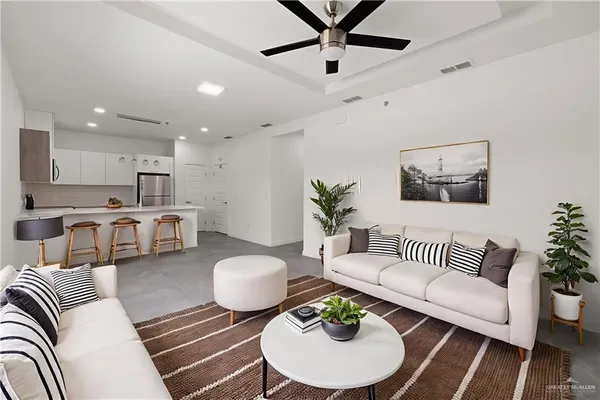 a living room with furniture kitchen view and a table