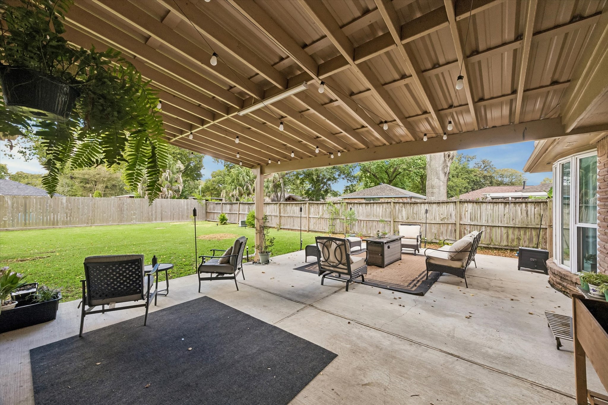 1931 Westlake Road Houston, TX 77062 - Photo 25 of 28 Step outside to a backyard that is anything but ordinary, with an expansive covered patio, open patio and sprawling fenced yard that gives you room to spread out, entertain and still have space to spare.