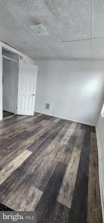 a living room with hard wood flooring