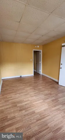 a view of an empty room and wooden floor