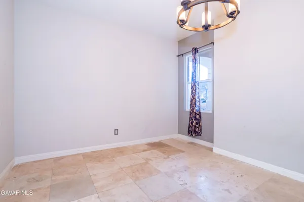 a view of wooden floor and a chandelier in a room