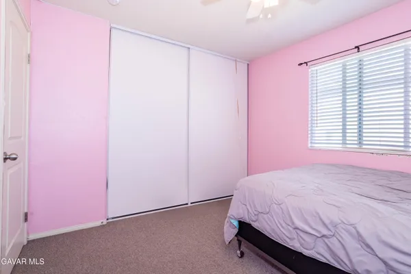 a bed room with a bed and a window