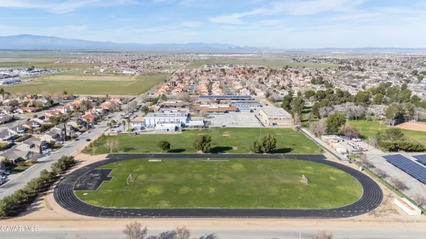 an aerial view of a house with a garden and lake view