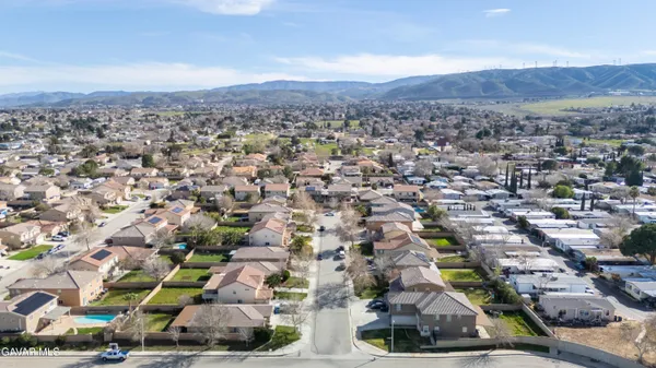 an aerial view of residential houses with outdoor space