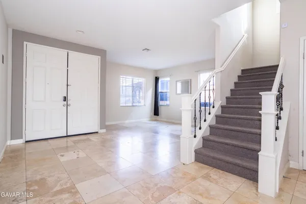 a view of entryway with wooden floor and stairs