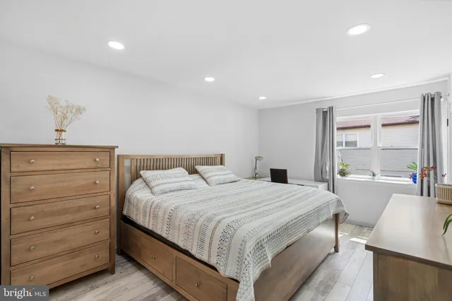 a bedroom with a bed and with furniture