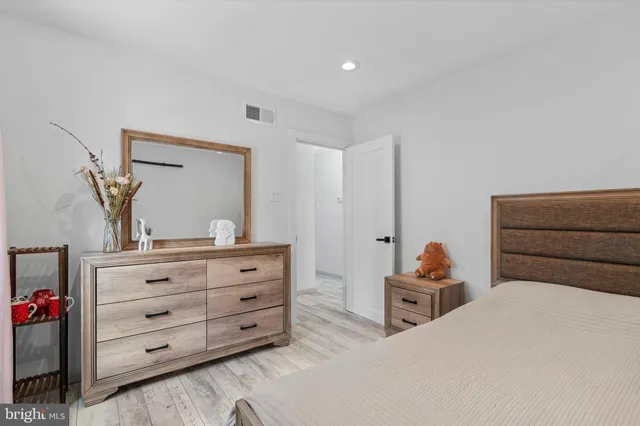 a bedroom with a bed and a dresser