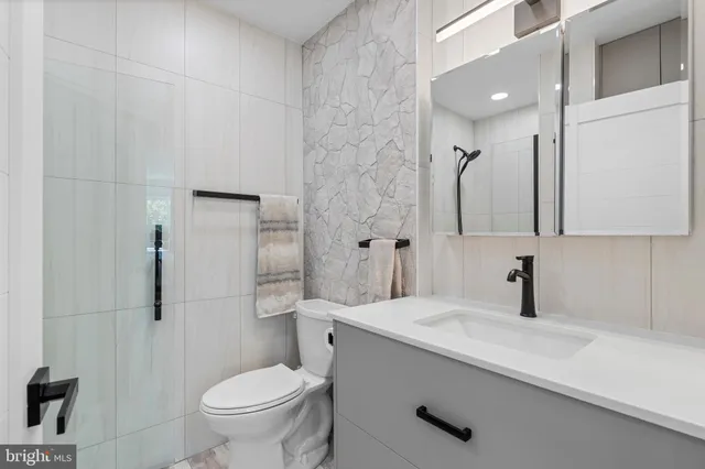 a bathroom with a sink toilet and shower