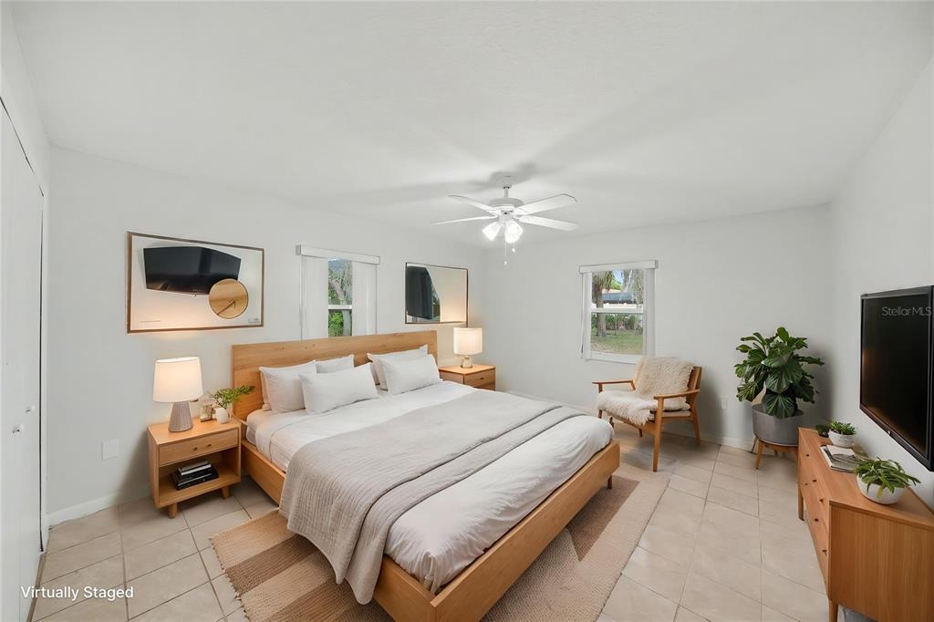 113 Ruskin Avenue Spring Hill, FL 34606 - Photo 14 of 32 a bedroom with a bed and a flat screen tv
