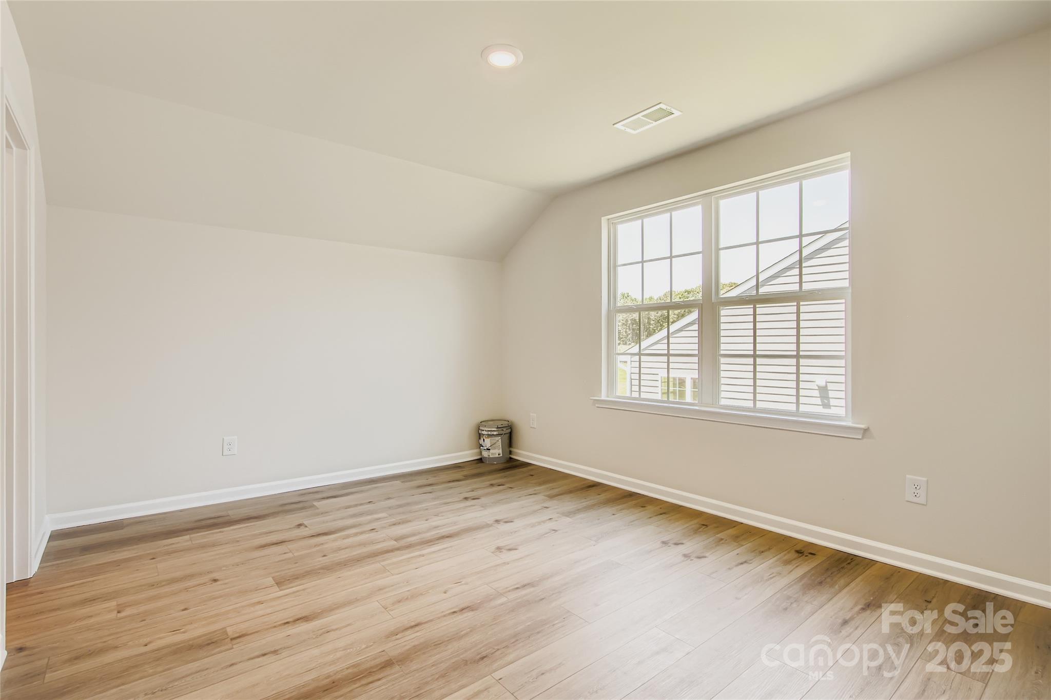 2831 Morning Song Way Lancaster, SC 29720 - Photo 12 of 18 an empty room with wooden floor and windows