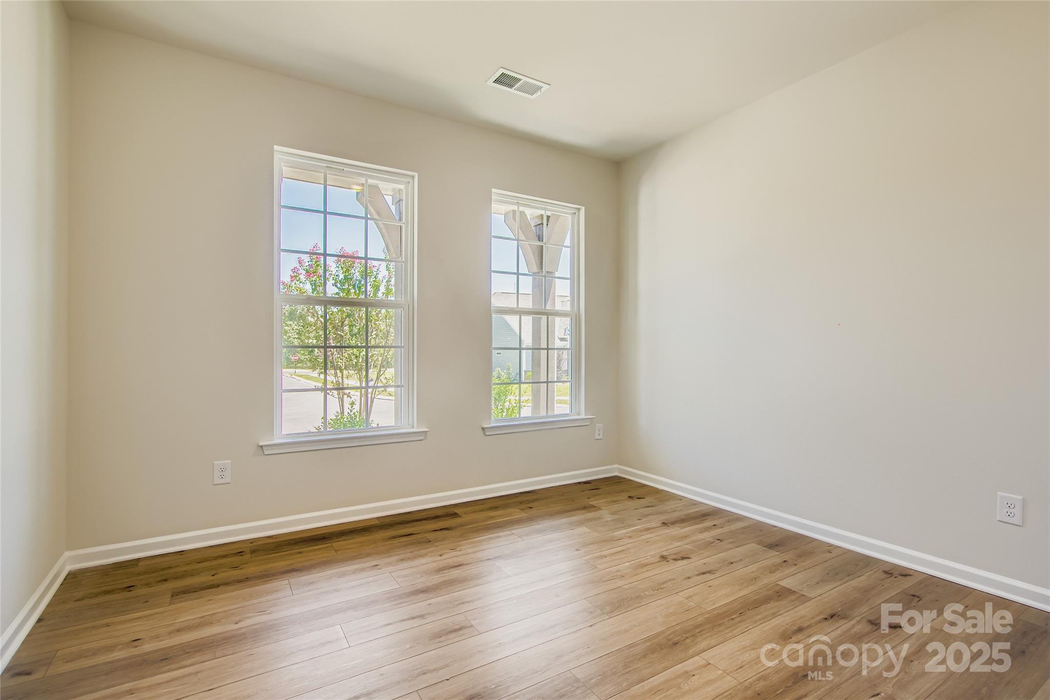 2831 Morning Song Way Lancaster, SC 29720 - Photo 10 of 18 an empty room with wooden floor and windows