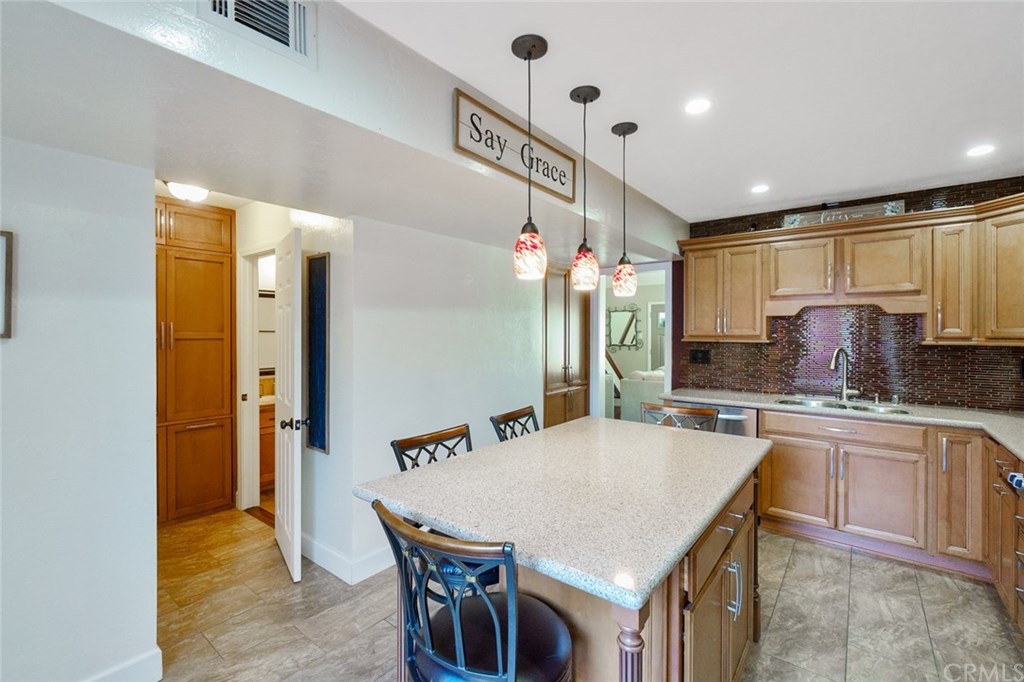 2419 Minuteman Way Costa Mesa, CA 92626 - Photo 15 of 26 a kitchen with stainless steel appliances granite countertop a sink refrigerator and cabinets