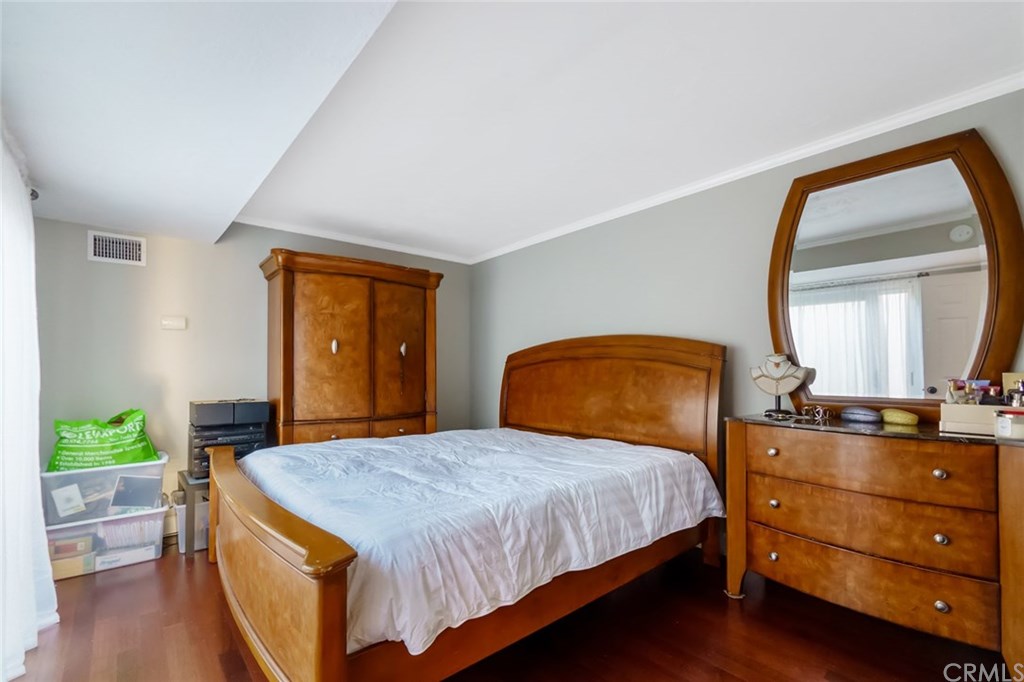 2419 Minuteman Way Costa Mesa, CA 92626 - Photo 16 of 26 a bedroom with a bed and a dresser