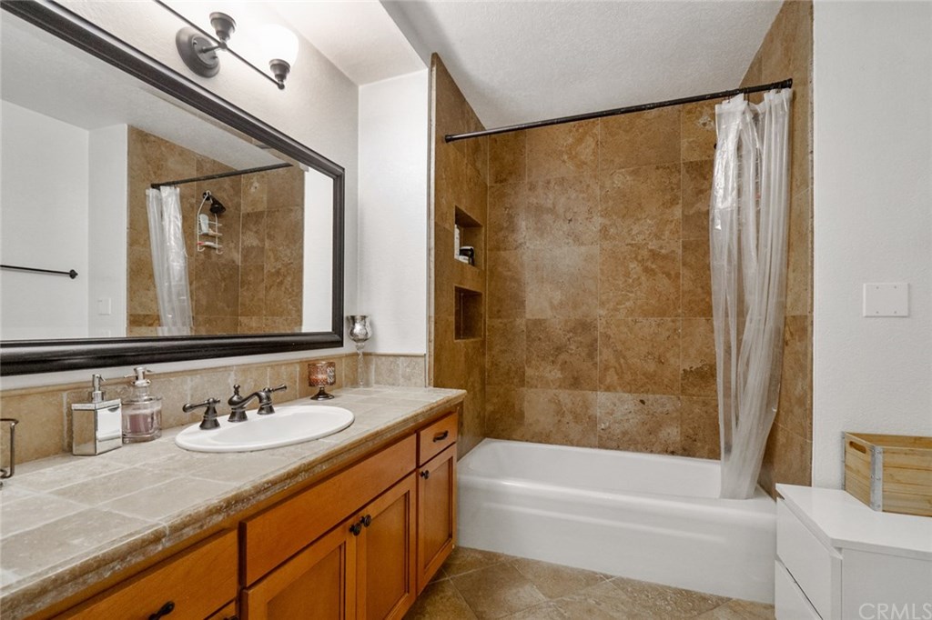 2419 Minuteman Way Costa Mesa, CA 92626 - Photo 17 of 26 a bathroom with a granite countertop sink and a mirror