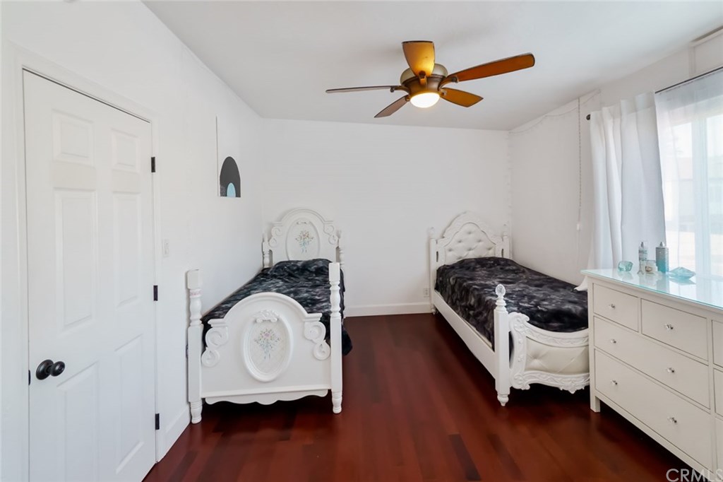 2419 Minuteman Way Costa Mesa, CA 92626 - Photo 19 of 26 a bedroom with a bed and a ceiling fan
