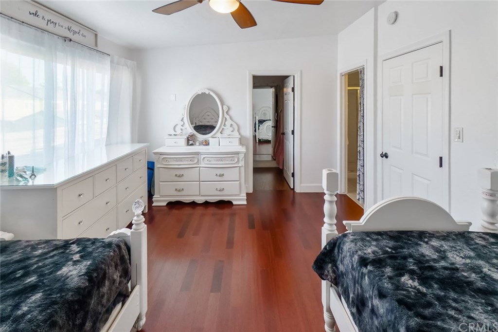 2419 Minuteman Way Costa Mesa, CA 92626 - Photo 21 of 26 a bedroom with a bed and wooden floor