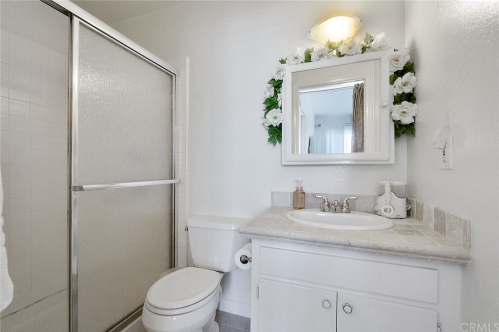 2419 Minuteman Way Costa Mesa, CA 92626 - Photo 22 of 26 a bathroom with a toilet a sink and mirror