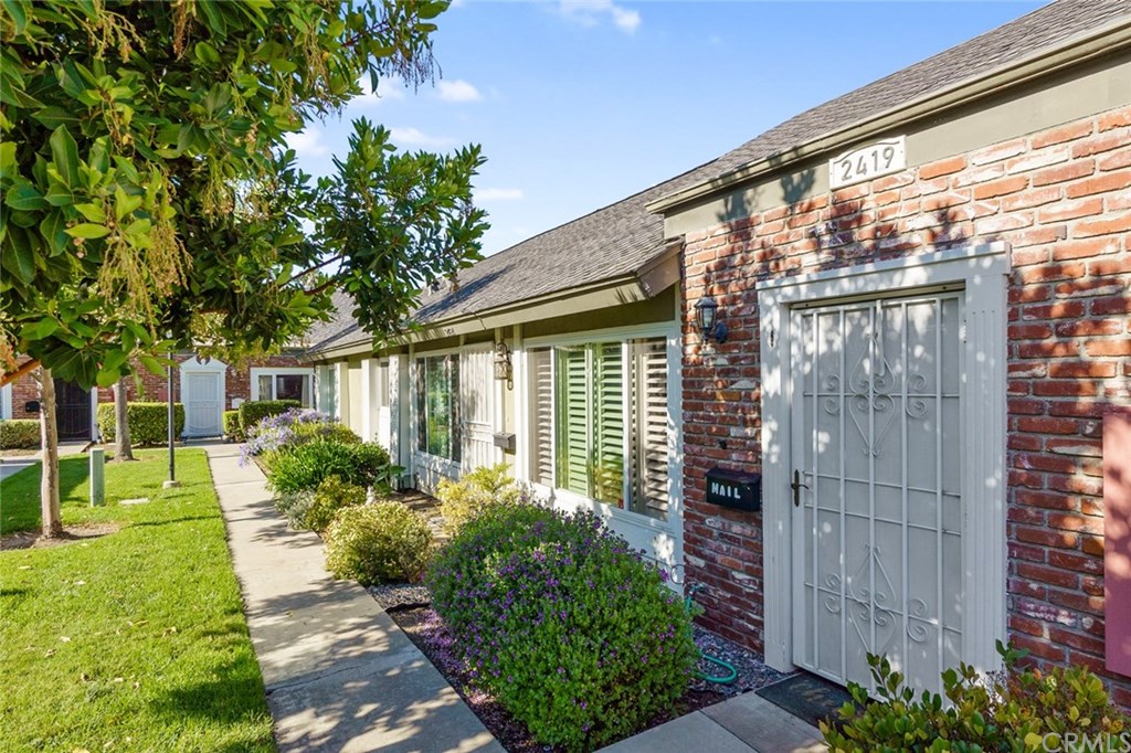 2419 Minuteman Way Costa Mesa, CA 92626 - Photo 25 of 26 a front view of a house with a yard