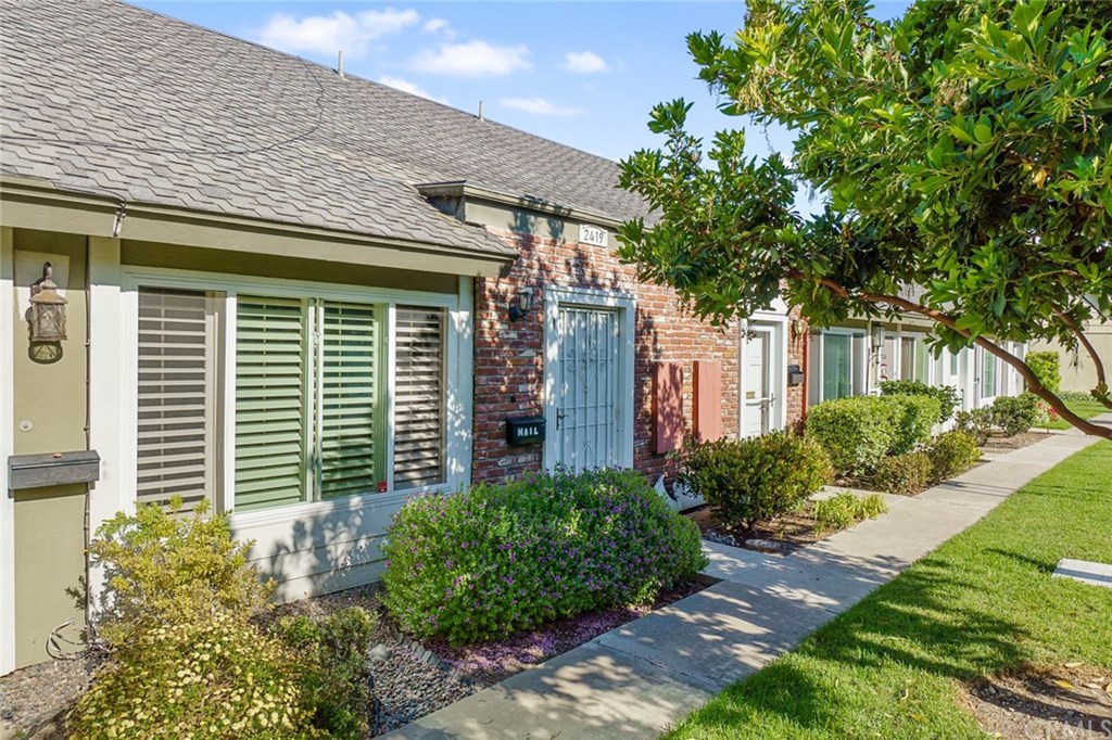 2419 Minuteman Way Costa Mesa, CA 92626 - Photo 4 of 26 a front view of a house with plants and garden