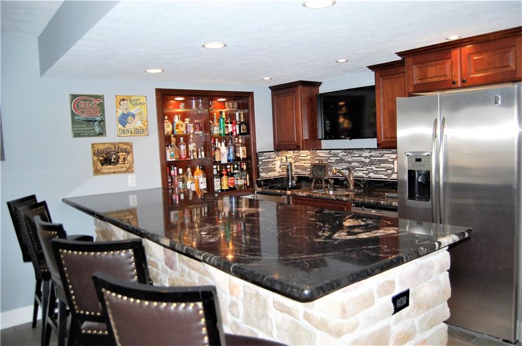 121 Timber Ridge Drive Harmony, PA 16037 - Photo 22 of 25 The bar area is sure to impress. Seating for five, a granite counter top, stainless steel appliances, custom blacksplash and stunning stone work will catch your attention.