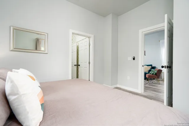 a bedroom with a bed and a mirror