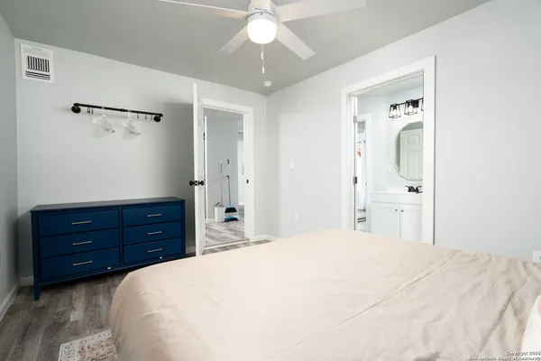 a bedroom with a bed and a dresser