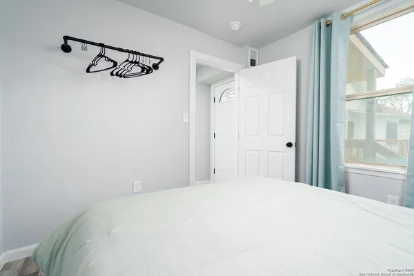 a bedroom with a large bed and a window