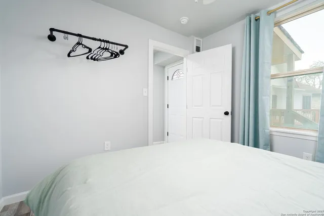 a bedroom with a large bed and a window