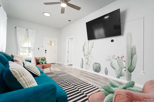 a bedroom with furniture and a flat screen tv